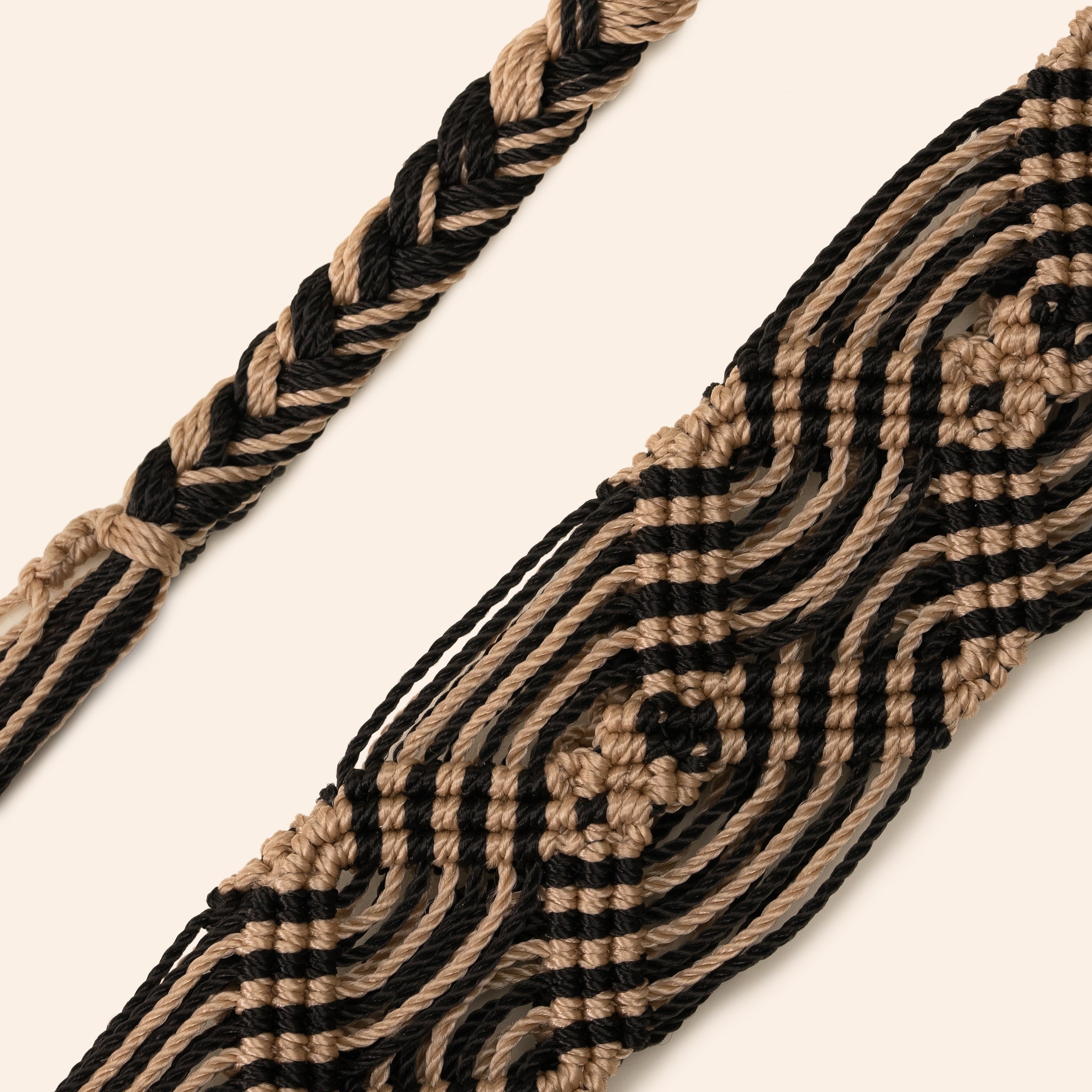 black and beige phone and bag strap